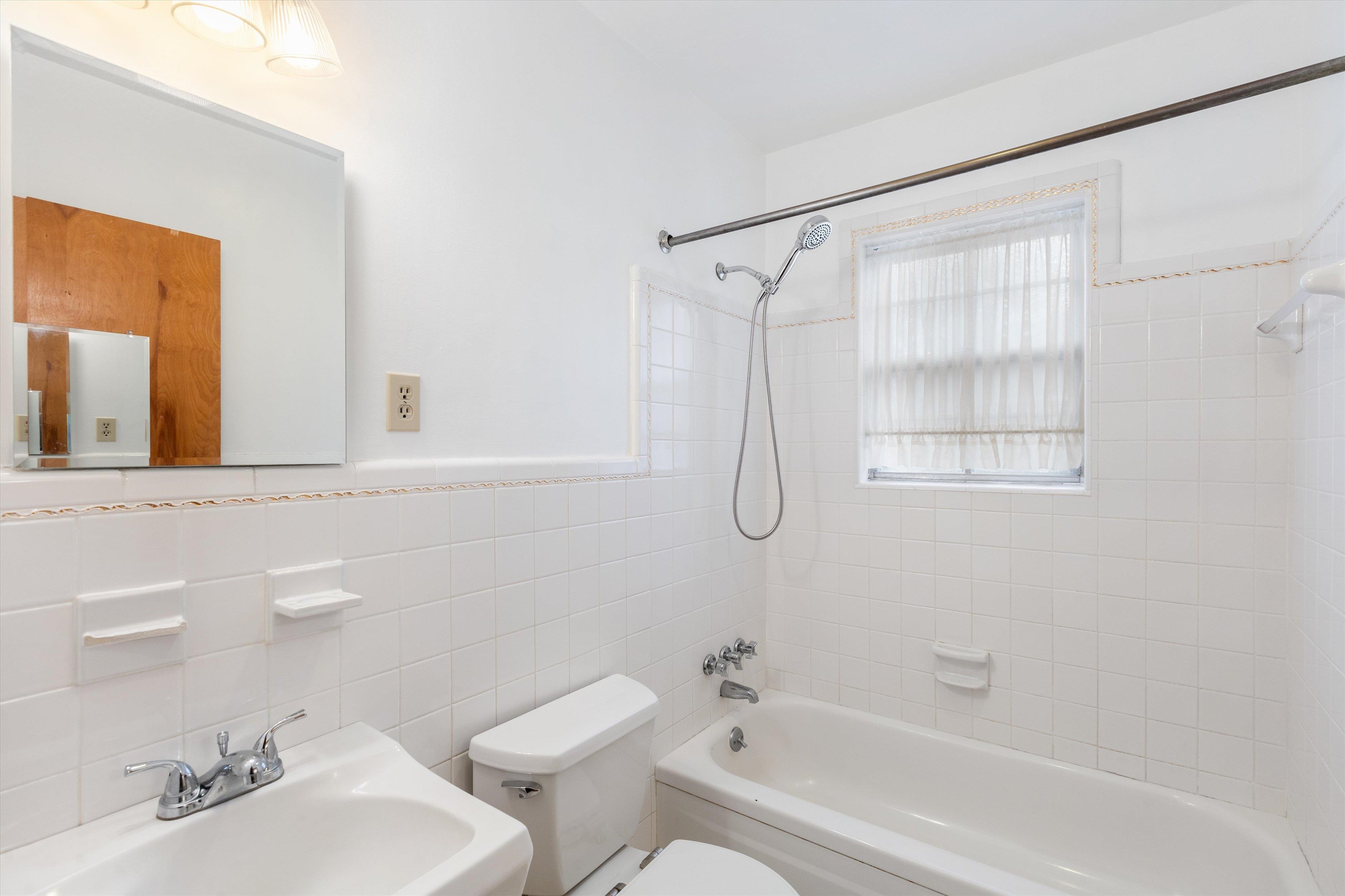 1217 Vaughn Road Memphis, TN 38122 - Photo 20 of 27 a bathroom with a sink mirror vanity and toilet