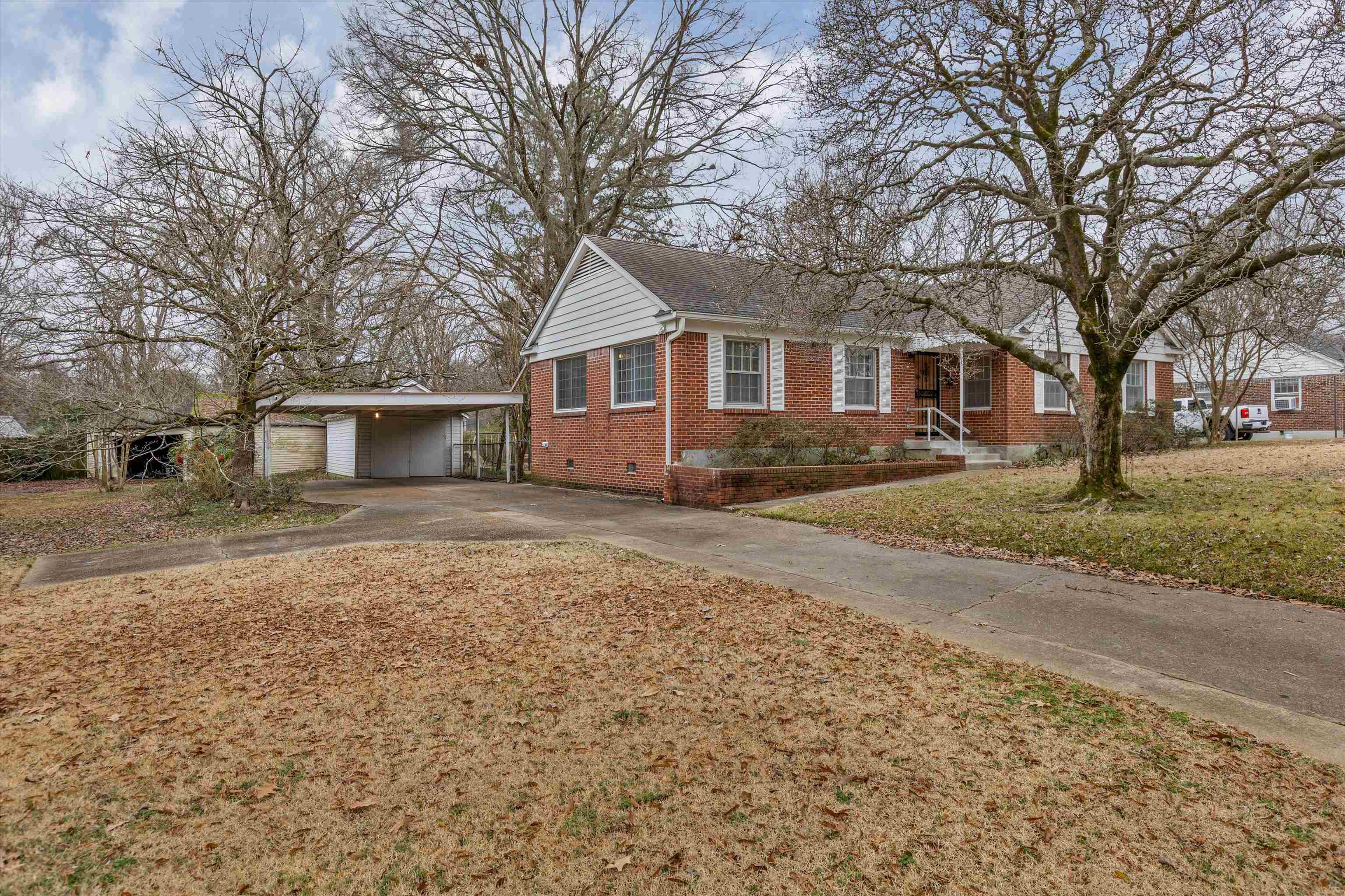 1217 Vaughn Road Memphis, TN 38122 - Photo 2 of 27 a front view of a house with a yard and trees