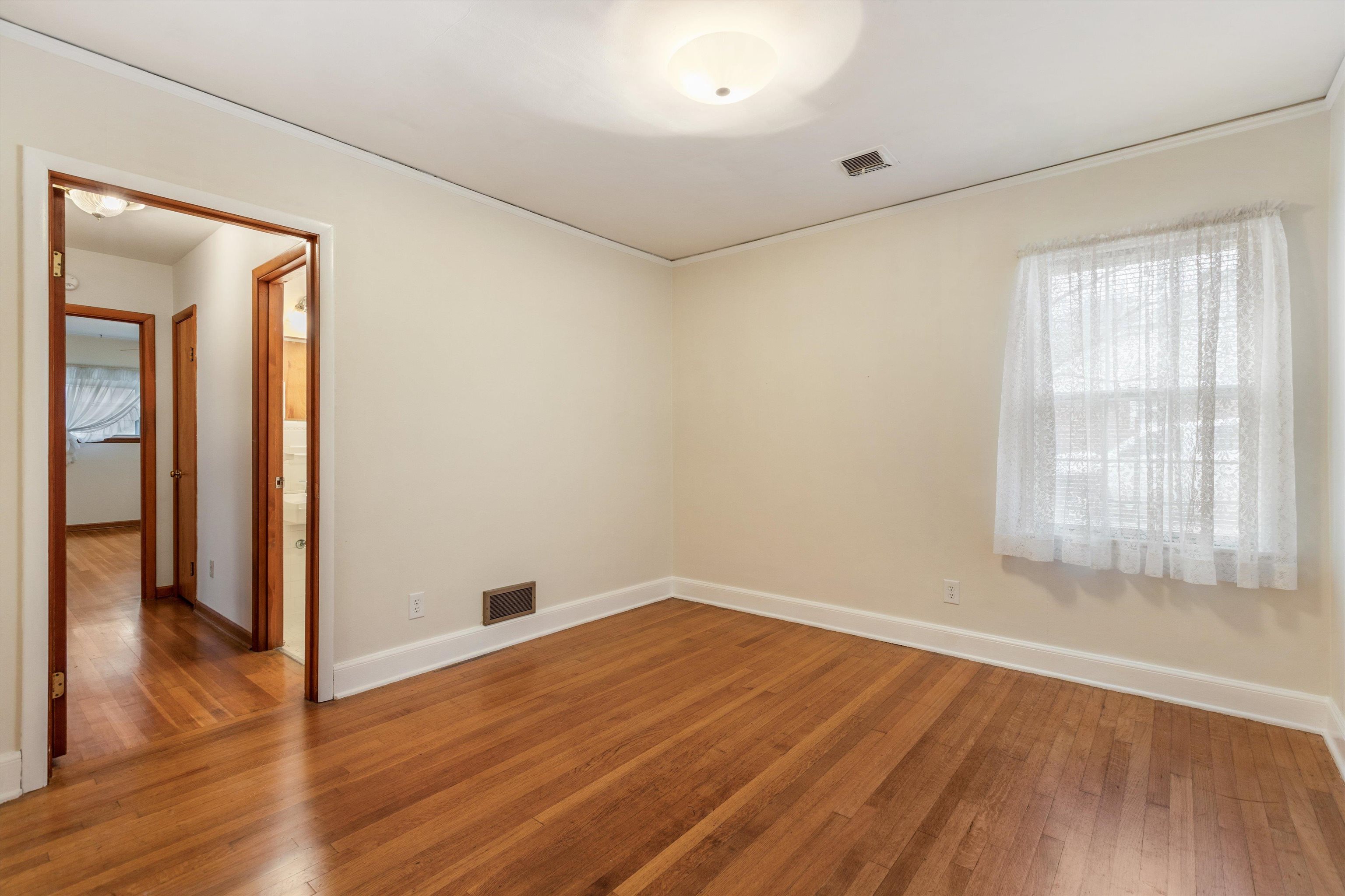 1217 Vaughn Road Memphis, TN 38122 - Photo 22 of 27 an empty room with wooden floor and windows
