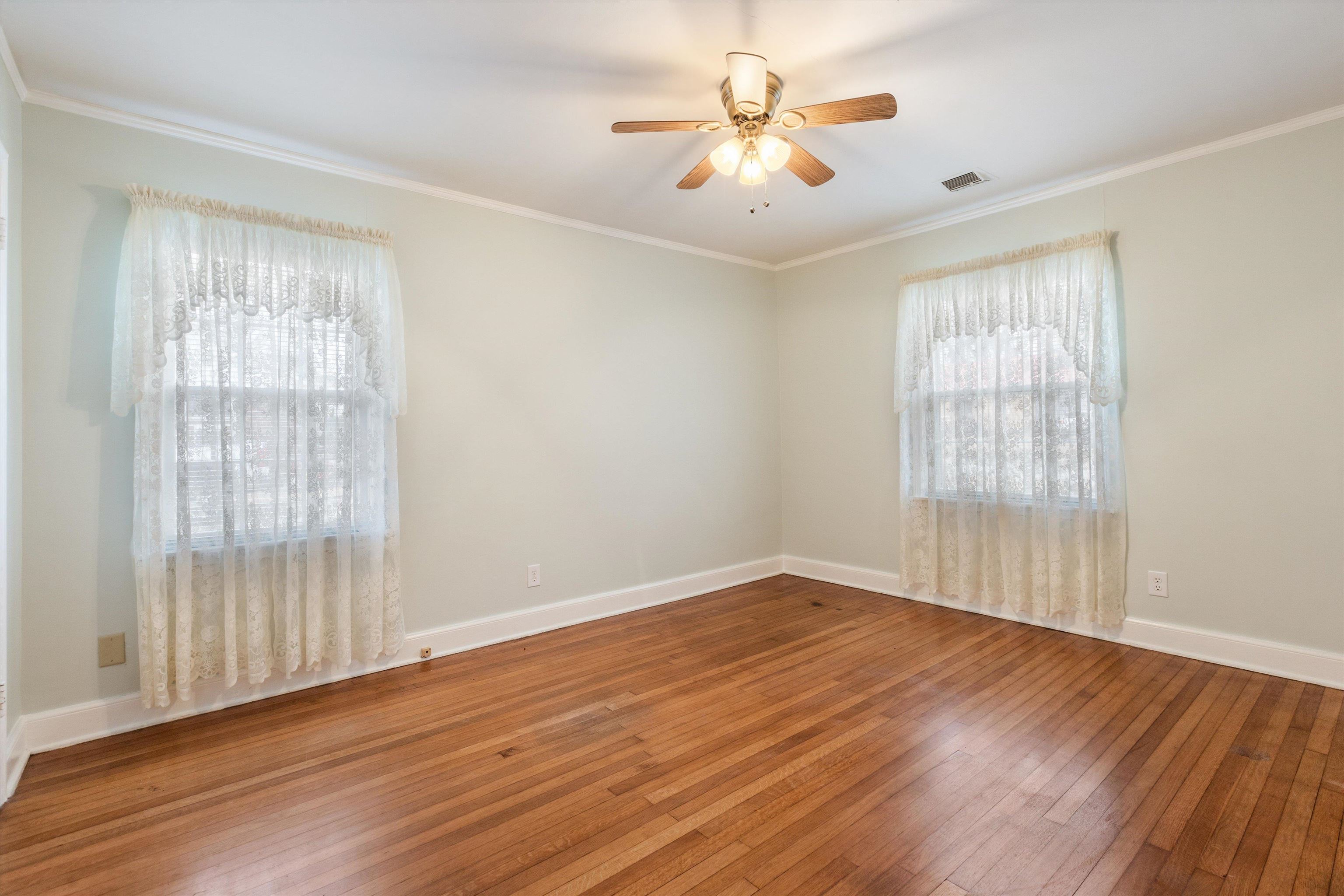1217 Vaughn Road Memphis, TN 38122 - Photo 23 of 27 an empty room with wooden floor and windows