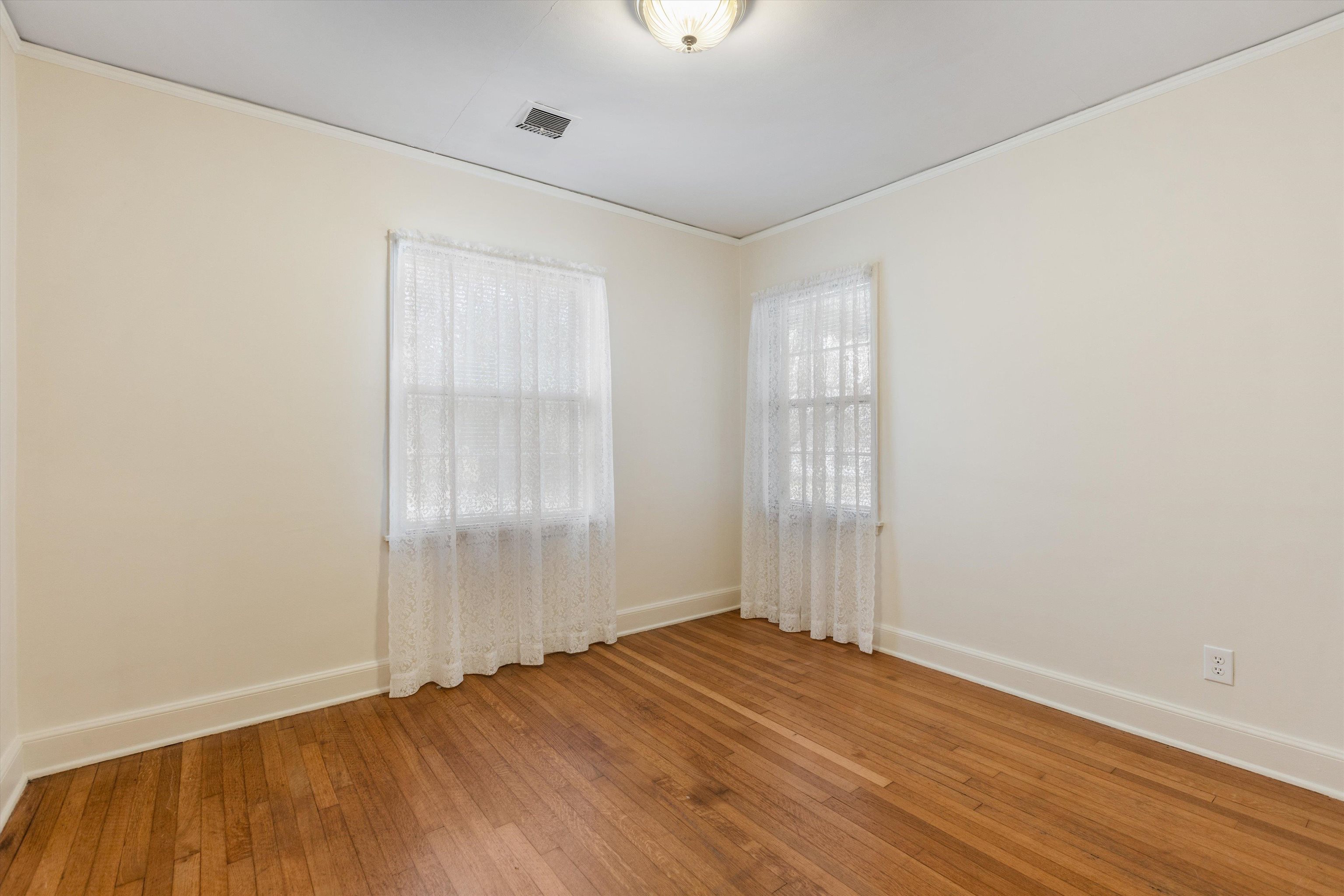 1217 Vaughn Road Memphis, TN 38122 - Photo 24 of 27 an empty room with wooden floor and windows