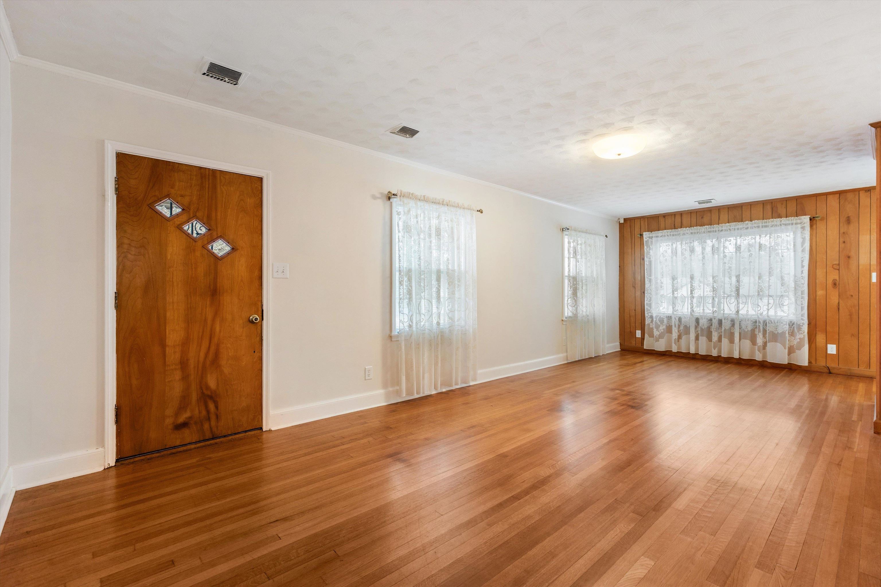 1217 Vaughn Road Memphis, TN 38122 - Photo 7 of 27 an empty room with wooden floor and windows