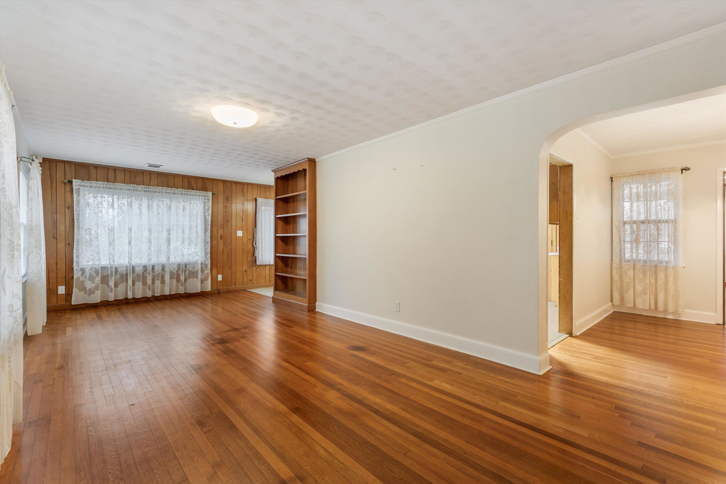 1217 Vaughn Road Memphis, TN 38122 - Photo 9 of 27 an empty room with wooden floor and windows