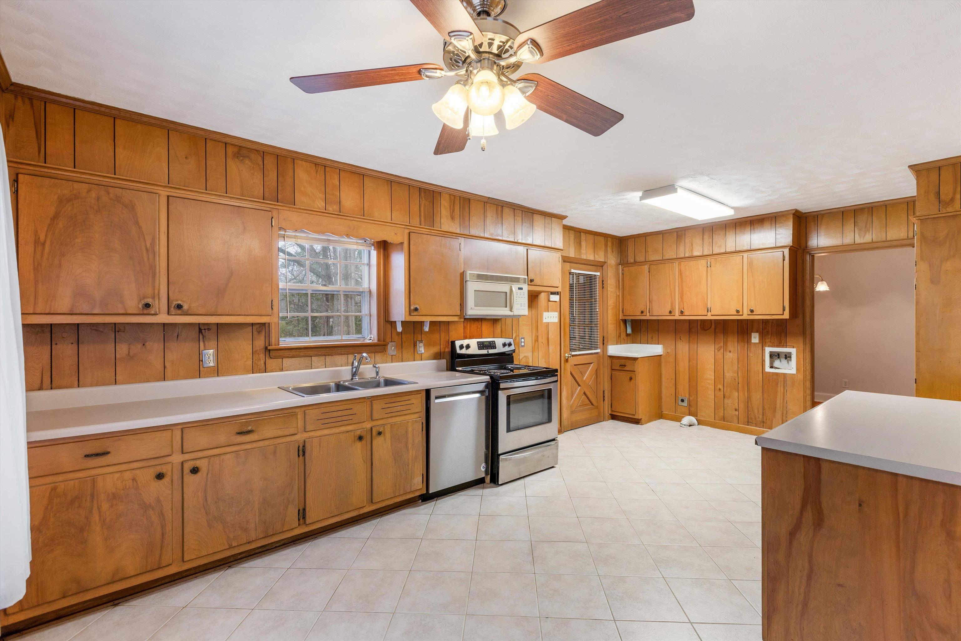 1217 Vaughn Road Memphis, TN 38122 - Photo 10 of 27 a large kitchen with stainless steel appliances granite countertop a refrigerator and a sink