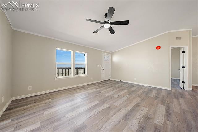 8160 Edison Road Yoder, CO 80864 - Photo 9 of 42 Empty room with ceiling fan, crown molding, and light wood-type flooring