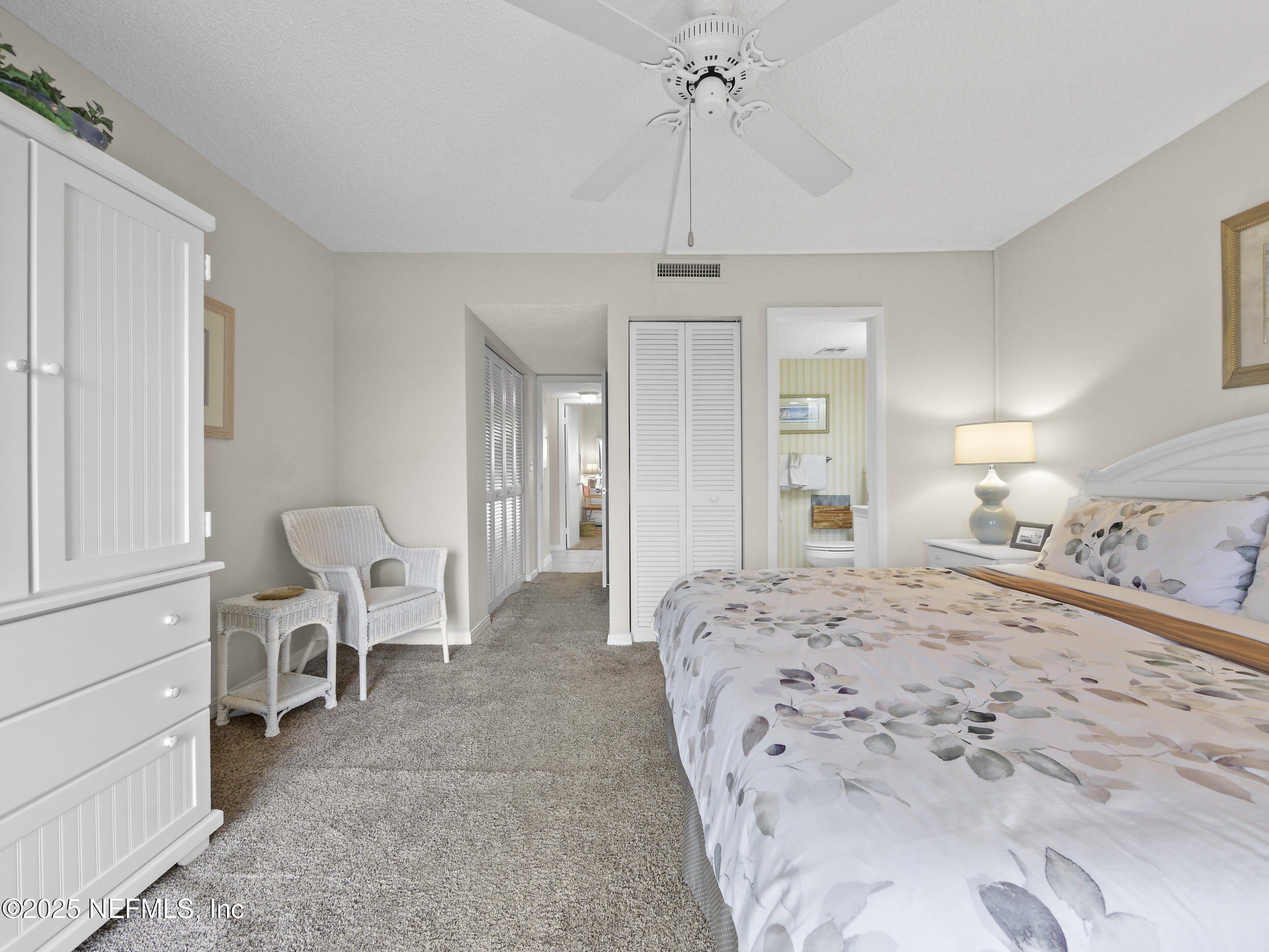4 Ocean Trace Road, Unit 424 St. Augustine, FL 32080 - Photo 27 of 38 a spacious bedroom with a bed and furniture