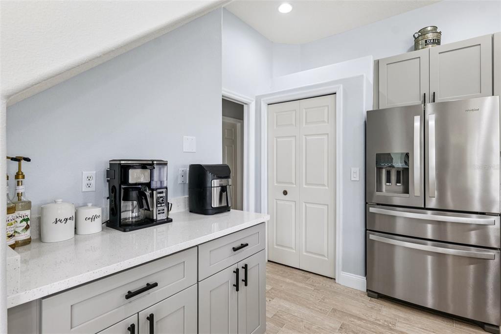 13049 Thoroughbred Drive Dade City, FL 33525 - Photo 11 of 52 a kitchen with refrigerator and cabinets