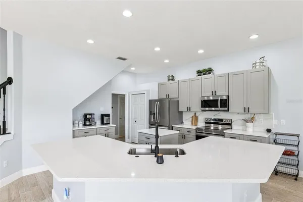 a kitchen with counter top space cabinets and stainless steel appliances