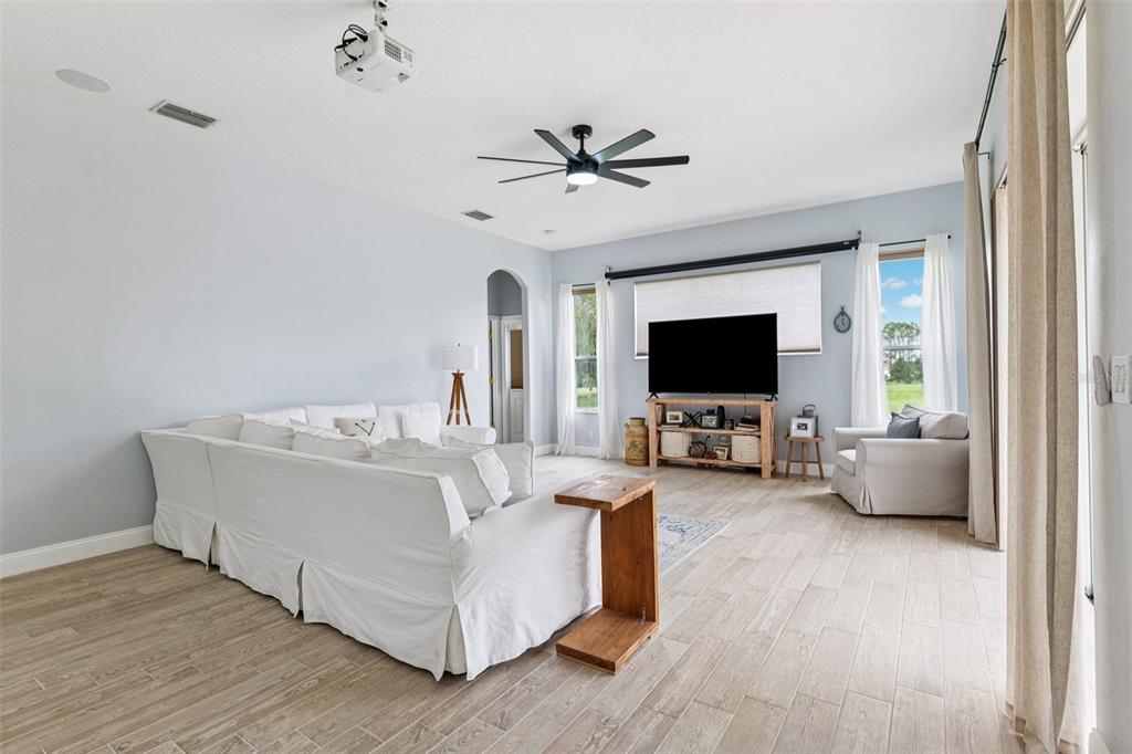 13049 Thoroughbred Drive Dade City, FL 33525 - Photo 17 of 52 a living room with furniture and a flat screen tv