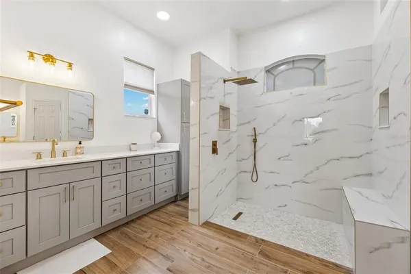 a spacious bathroom with double sink and shower