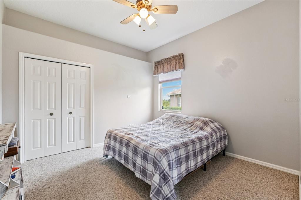 13049 Thoroughbred Drive Dade City, FL 33525 - Photo 23 of 52 a bedroom with a bed and a chandelier