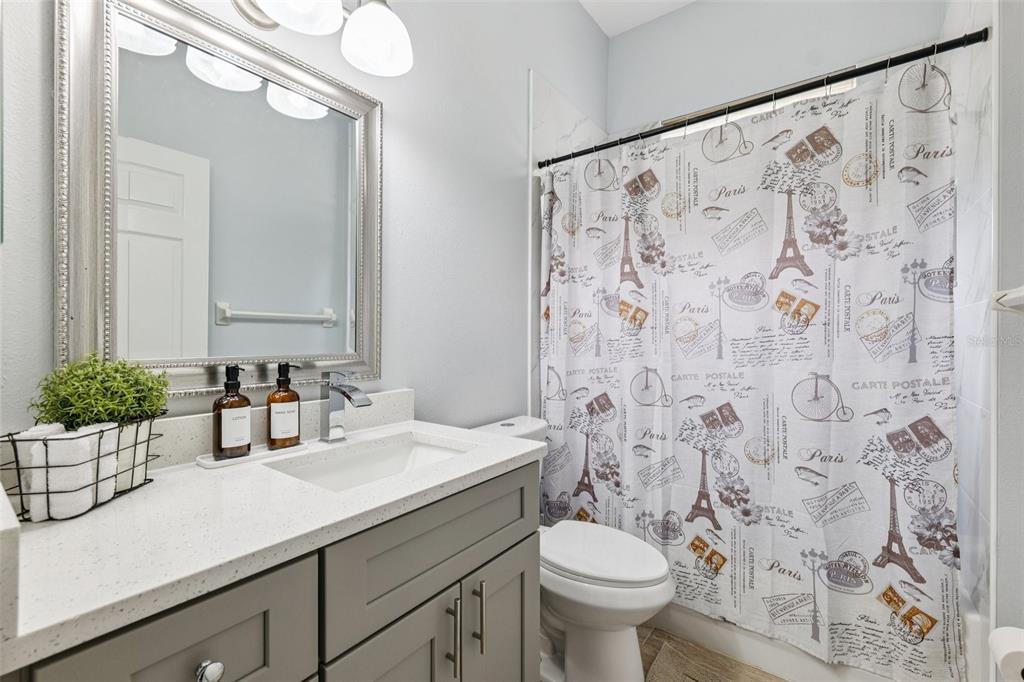 13049 Thoroughbred Drive Dade City, FL 33525 - Photo 24 of 52 a bathroom with a sink and mirror with toilet