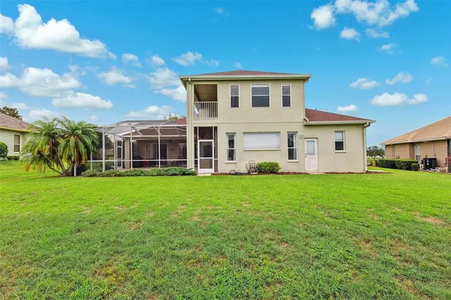 a view of a house with backyard sitting area and garden