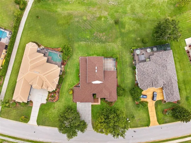 an aerial view of a house with outdoor space and a lake view