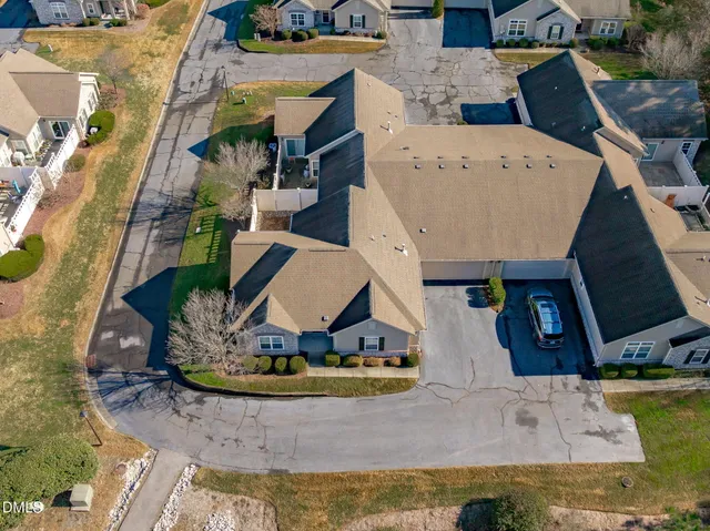 a view of a house with a wooden fence