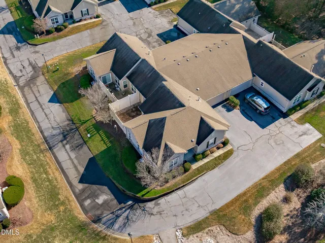 a front view of house with yard and trees around