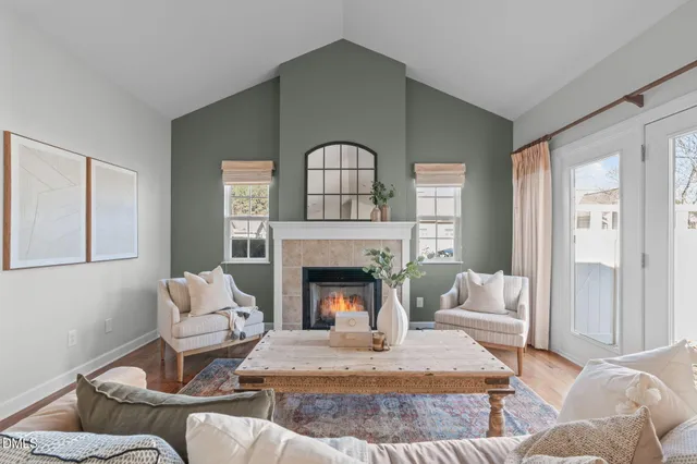 a living room with furniture fireplace and window