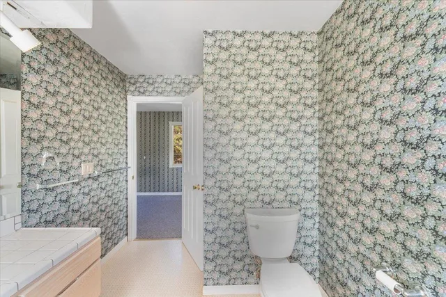 a view of a kitchen with microwave and refrigerator