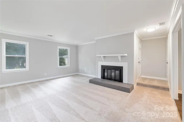 a view of a livingroom with a fireplace and window