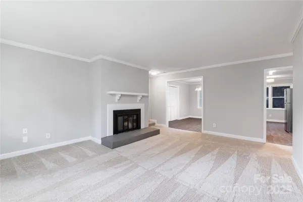 a view of an empty room with a fireplace