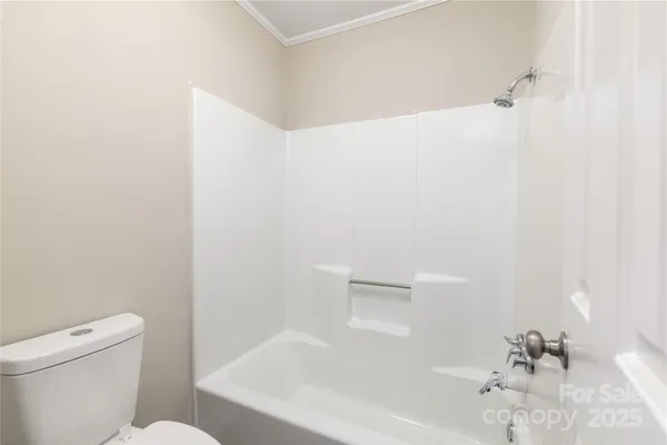 a bathroom with a bathtub and a toilet