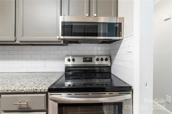 a stove top oven sitting inside of a kitchen