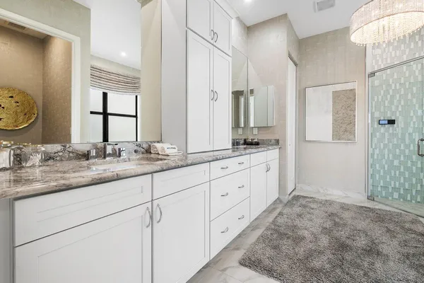 a bathroom with double sink and a mirror