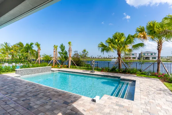 a swimming pool with outdoor seating and yard
