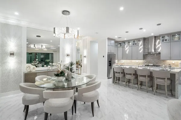 a dining room with kitchen island a dining table and chairs