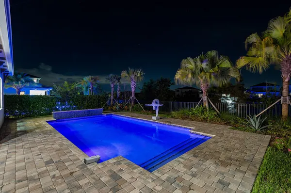 a view of a pool in the backyard of house