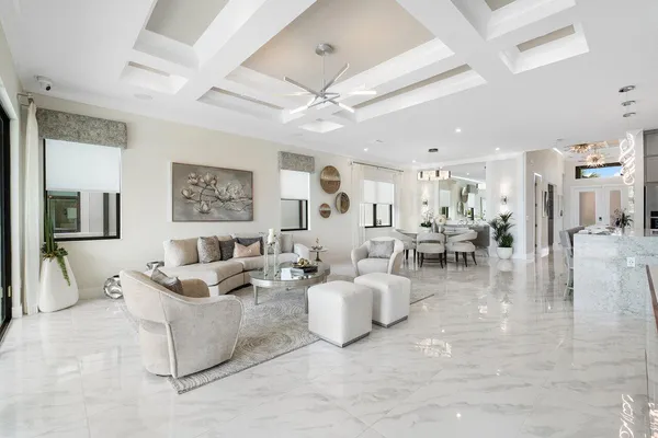 a living room with furniture and a view of kitchen