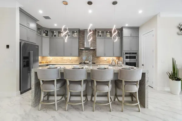 a large kitchen with a table and chairs