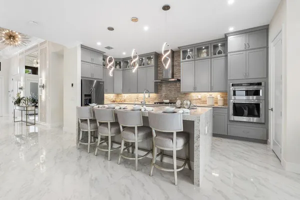 a large kitchen with a table and chairs