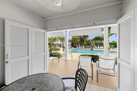 a dining room with furniture and a floor to ceiling window