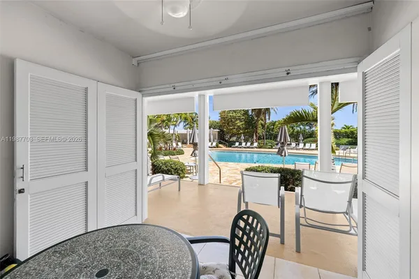 a dining room with furniture and a floor to ceiling window