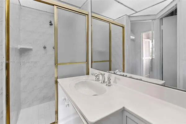 a bathroom with a sink and shower