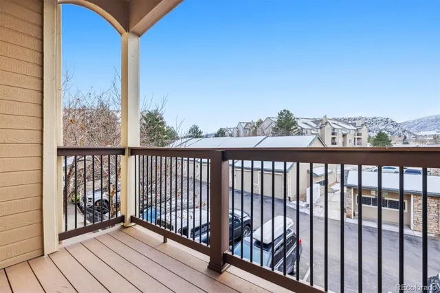 a view of a balcony with wooden floor and city view