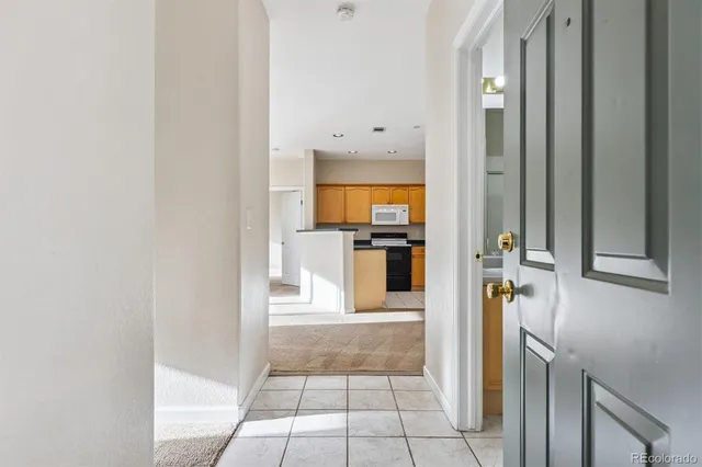 a view of a hallway with a kitchen