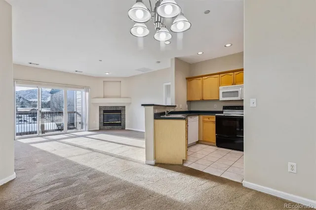 a view of an empty room with a fireplace and a window