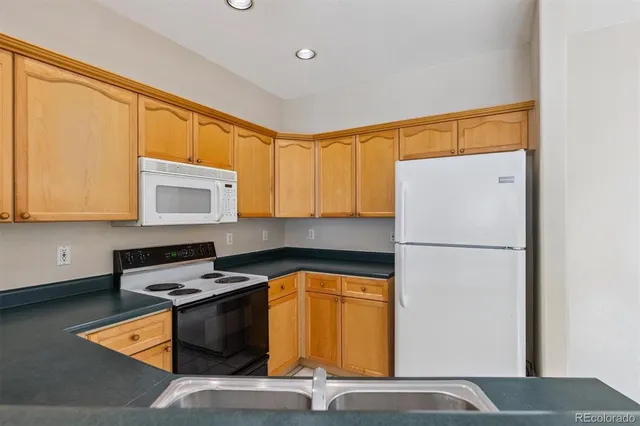 a kitchen with a sink appliances and cabinets