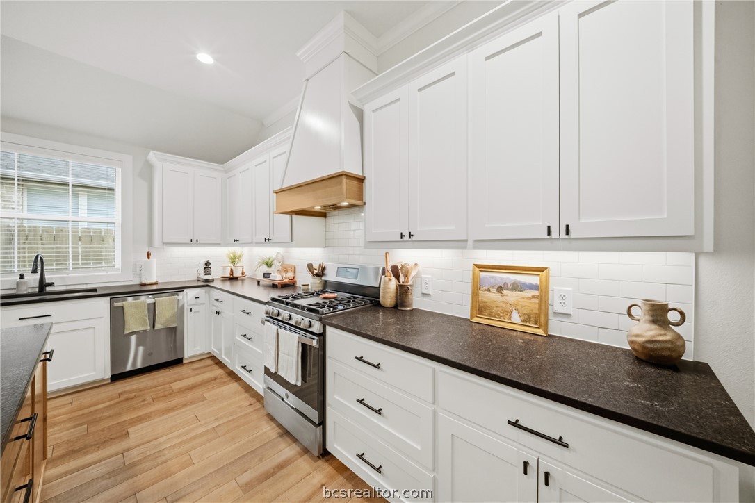 3520 Fairhope Way Bryan, TX 77808 - Photo 11 of 39 a kitchen with granite countertop white cabinets and white appliances