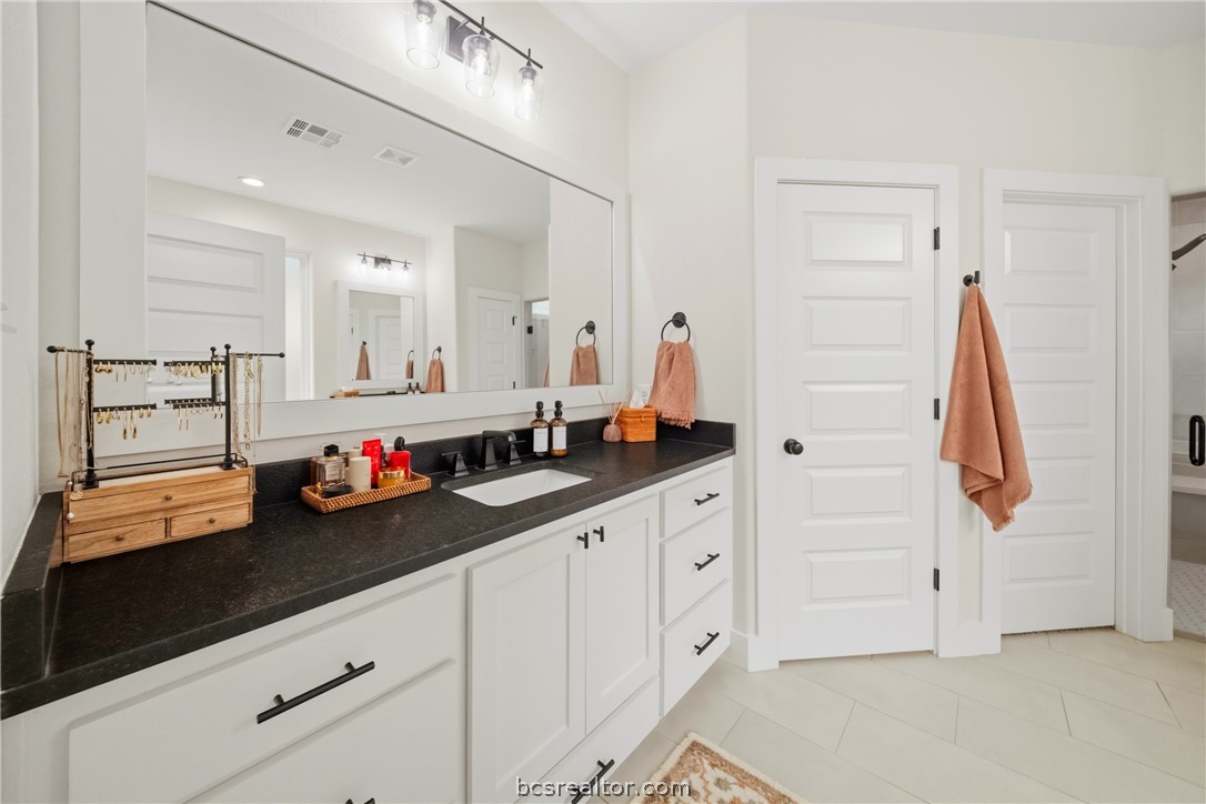 3520 Fairhope Way Bryan, TX 77808 - Photo 16 of 39 a bathroom with a sink and a mirror