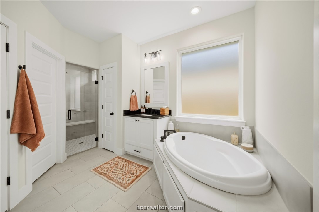 3520 Fairhope Way Bryan, TX 77808 - Photo 17 of 39 a bathroom with a tub sink and mirror