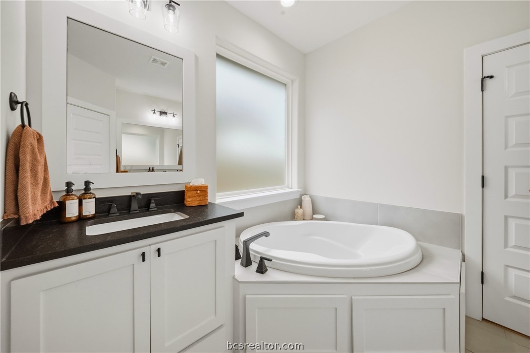 3520 Fairhope Way Bryan, TX 77808 - Photo 18 of 39 a bathroom with double sink and a mirror