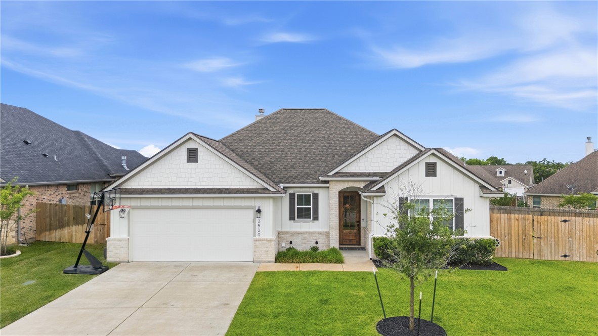 3520 Fairhope Way Bryan, TX 77808 - Photo 2 of 39 a front view of a house with a garden and yard
