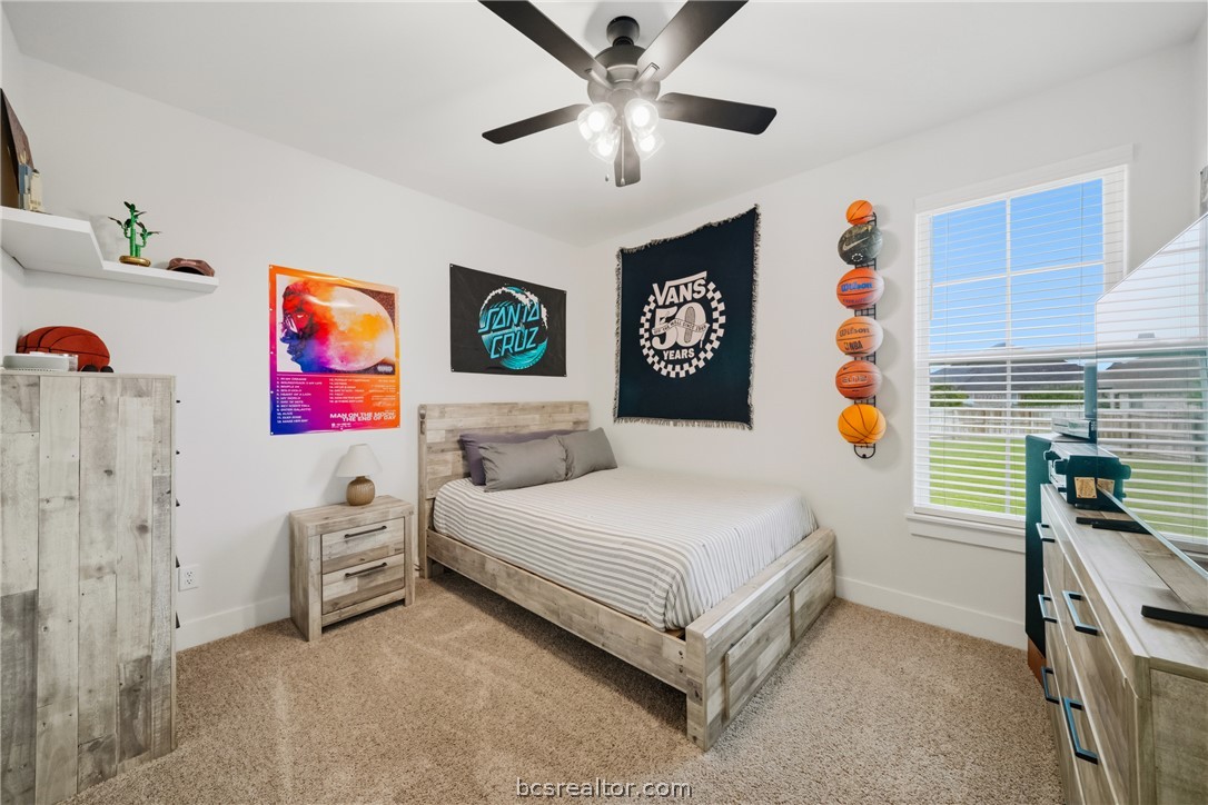 3520 Fairhope Way Bryan, TX 77808 - Photo 25 of 39 a bedroom with a bed and a chandelier