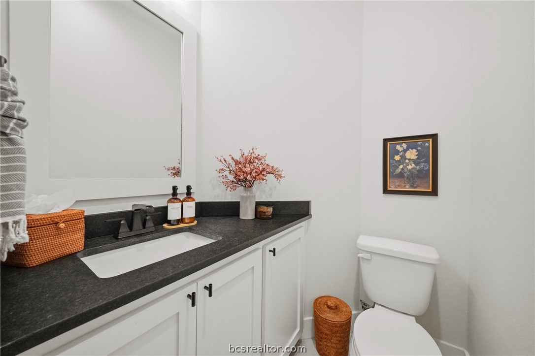 3520 Fairhope Way Bryan, TX 77808 - Photo 28 of 39 a bathroom with a granite countertop sink and a mirror