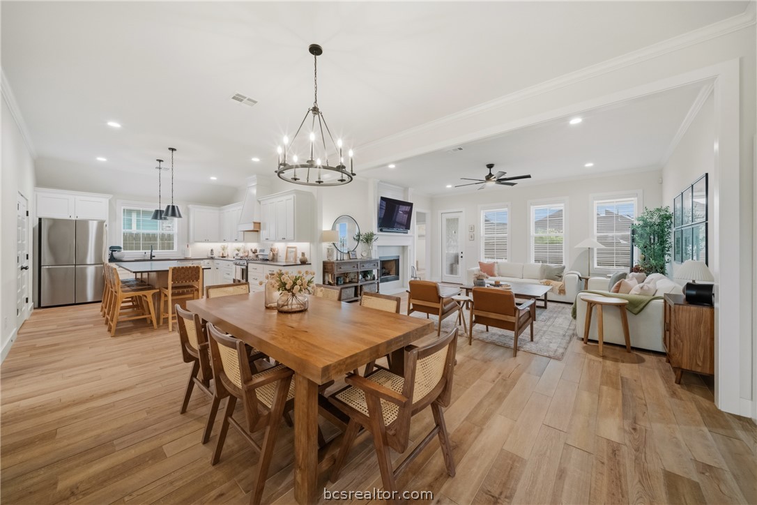 3520 Fairhope Way Bryan, TX 77808 - Photo 6 of 39 a view of a dining room and livingroom with furniture wooden floor a chandelier