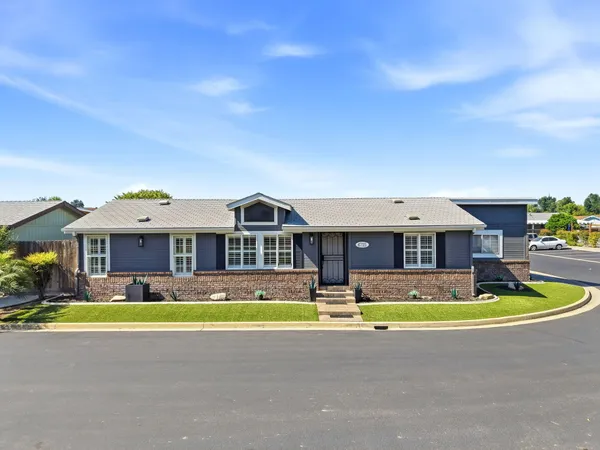 a front view of residential houses with yard and swimming pool