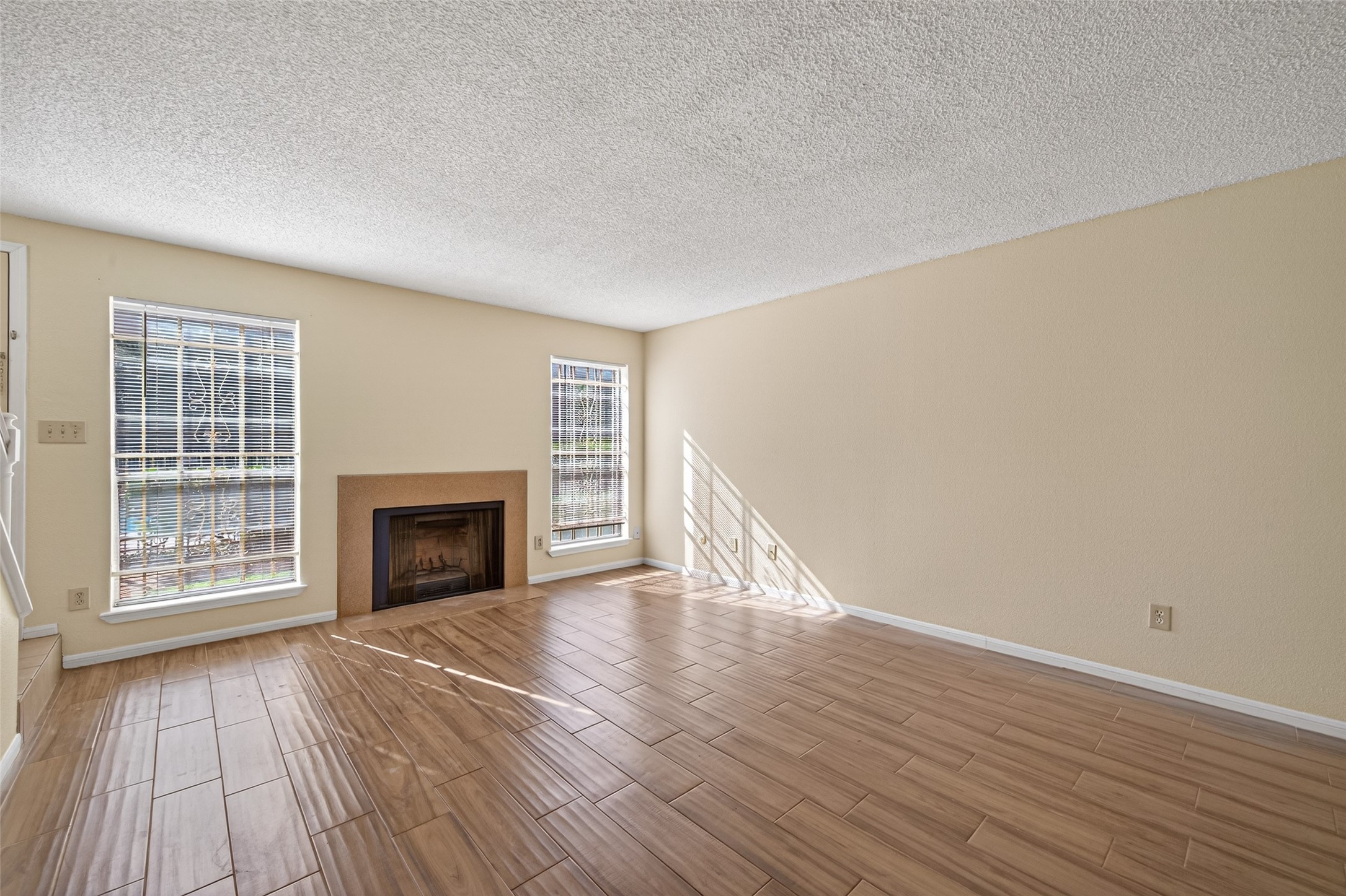3100 Jeanetta Street, Unit 1004 Houston, TX 77063 - Photo 9 of 42 The wood-burning fireplace is flanked by nearly floor-to-ceiling windows that frame peaceful outdoor views.